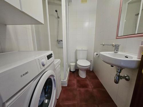 a bathroom with a washing machine and a sink at 14A08 Coqueto apartamento en la Isla in Colunga