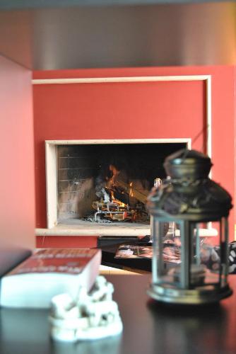 a remote control sitting on a table in front of a fireplace at Bed & Breakfast Valeri in Artena