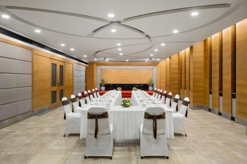 a conference room with a long table and chairs at Ginger Kochi MG Road in Cochin