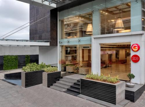 a building with some plants in front of it at Ginger Kochi MG Road in Cochin