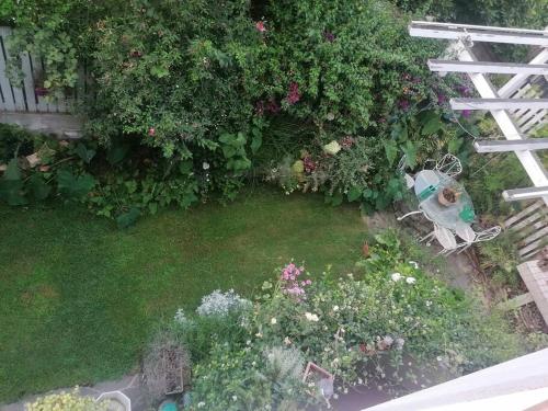 an aerial view of a garden with flowers and a white fence at NiMa in Cagliari