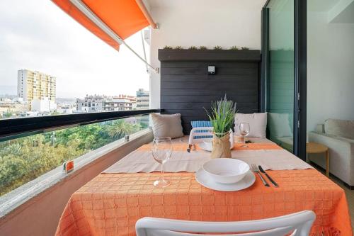 a table with a plate on it on a balcony at Estudio con terraza vista mar in Las Palmas de Gran Canaria
