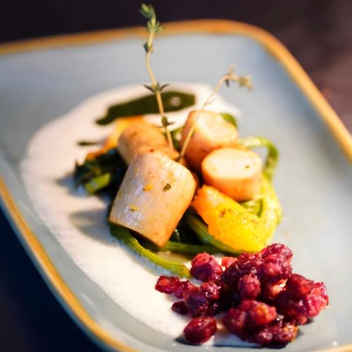 a plate of food with vegetables on a table at Vegan Hotel und Restaurants Nicolay 1881 in Zeltingen-Rachtig