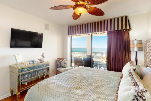 a bedroom with a bed and a view of the ocean at White Caps 203 in Orange Beach