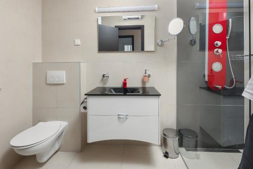 a bathroom with a white toilet and a sink at Residences Bellavista 3 in Novalja