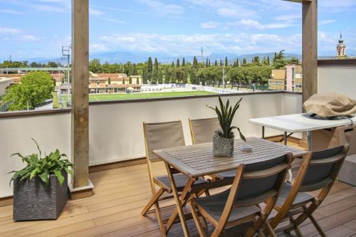 a balcony with a table and chairs and a view of a city at Appartamento VITTORIA in Verona