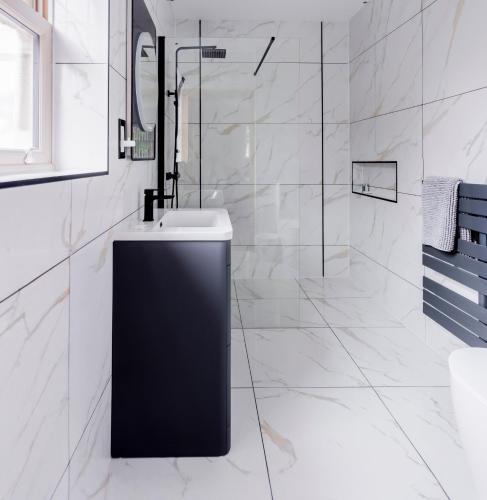 a white bathroom with a sink and a mirror at New fully furnished 5 bedroom, 4 bathroom detached houses in Leicester