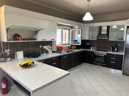 a kitchen with a counter with bananas on it at Villa Long View in Avliótai