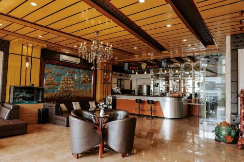 a lobby with a bar with leather chairs and a counter at Thao Vy Hotel in Hai Phong