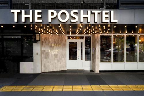 a restaurant with a sign on the front of a building at The poshtel Bangkok By Benya in Bangkok