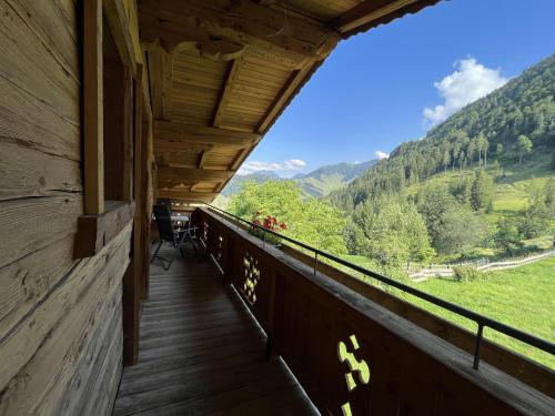 a balcony of a cabin with a view of the mountains at Bioberghof Rohr in Fieberbrunn