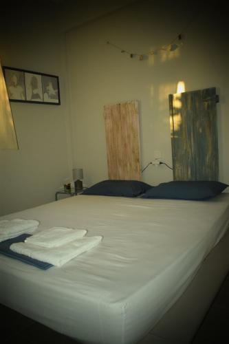 a white bed with towels on it in a bedroom at Seaside resort- kallithea in Kallithéa