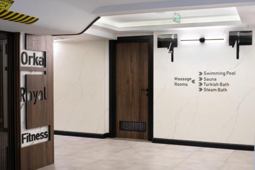 a hallway with a door and a sign on the wall at Orka Royal Hotel & Spa in Istanbul