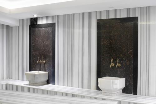 a bathroom with two toilets on a wall at Orka Royal Hotel & Spa in Istanbul