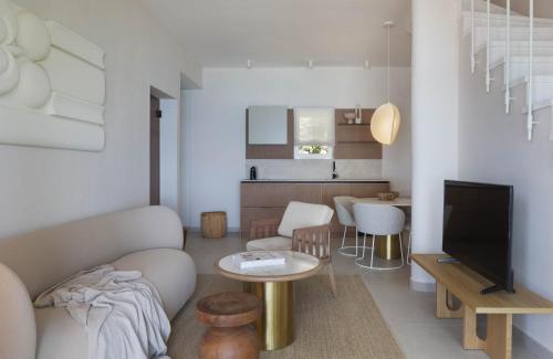 a living room with a couch and a tv and a table at Villa Berulia in Brela