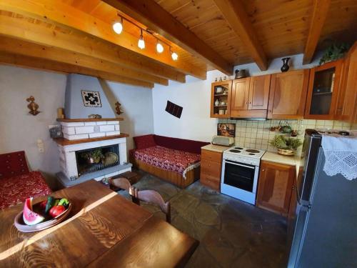 a kitchen with a table and a stove top oven at Παραδοσιακό Σπίτι στο Μονοδένδρι in Monodendri