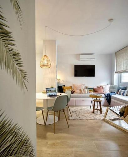 a living room with a table and a couch at Casa Xava Valencia in Valencia