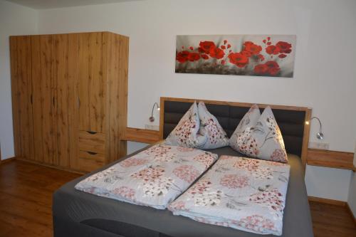 a bedroom with a bed with pillows on it at Appartement Wieshof in Neukirchen am Großvenediger