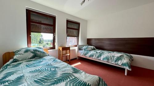 a bedroom with two beds and a window at Haus - mit Grundstück und Privatparkplatz in Itzehoe