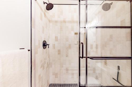a shower with a glass door in a bathroom at The Wedshire in Vail
