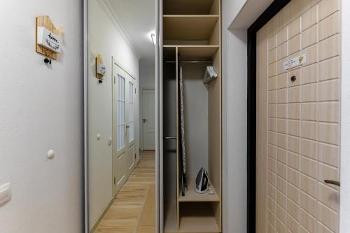 a hallway with a mirror and a walk in closet at ЖК "Light House", 1 in Astana