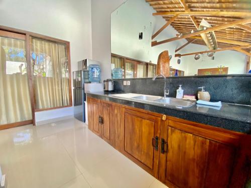 a kitchen with a sink and a counter at Villa Belharra in Seminyak