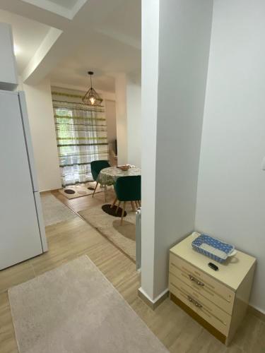 a living room with a table and a dining room at Pirlitor Mountain Apartment in Žabljak