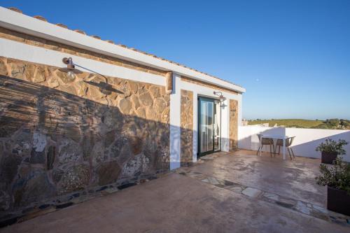 a patio with a table on the side of a building at Agroturismo Son Vives Menorca - Adults Only in Ferreries