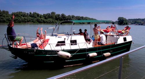a group of people on a boat on the water at ArkaBarka Floating Hostel in Belgrade