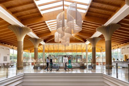 a rendering of the lobby of a building with a chandelier at Hipotels Barrosa Palace & Spa in Chiclana de la Frontera