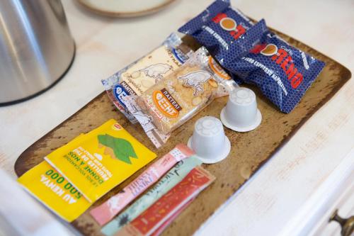 a wooden cutting board with snacks and toothpaste on it at BELLA VITA boutique hotel lefkada in Lefkada Town