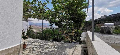 a balcony with a view of the mountains at Hazmurat Hotel in Gjirokastër