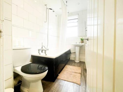 uma casa de banho com um WC, uma banheira e um lavatório. em Nicely Decorated 4BR, w/ Foosball Table and more! em Liverpool