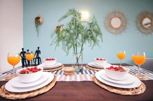 a table with plates and bowls of fruit on it at Bristol Short Stays College Green, 2 Bed Parking in Bristol