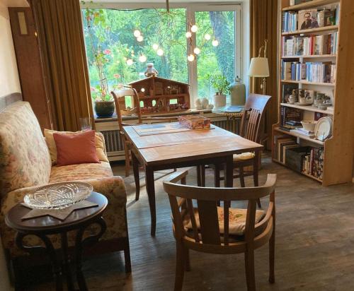 a living room with a wooden table and chairs at FeWo Olga Behrends in Wiesmoor