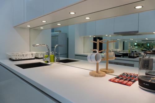 a kitchen with a counter with a sink and a counter at Yemala Suites @ Vortex KLCC in Kuala Lumpur