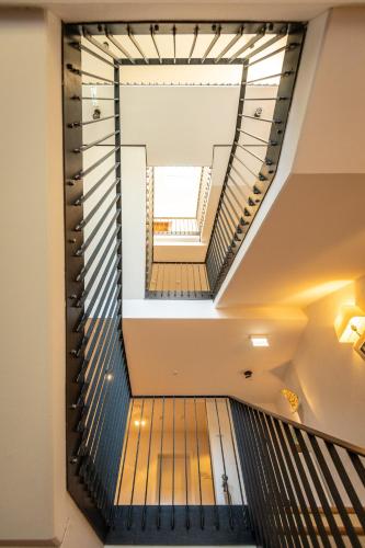 a spiral staircase in a building with a skylight at BollAnts Spa im Park in Bad Sobernheim