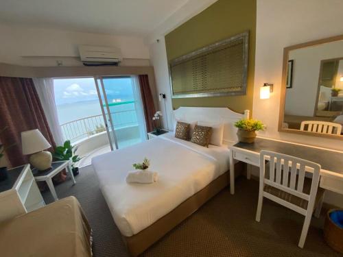 a bedroom with a large bed with a view of the ocean at Beachfront Sea View Penang in Tanjung Bungah