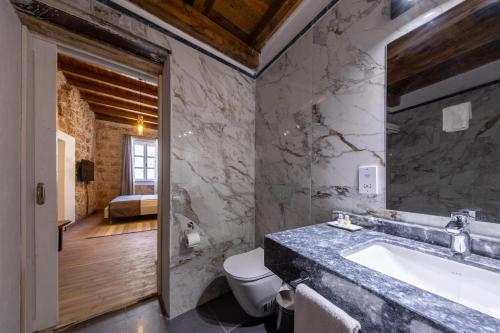 a bathroom with a sink and a toilet at La Regina Veneziana in Famagusta