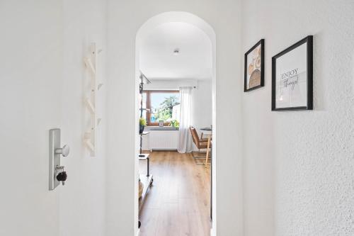 a hallway with a white door and a dining room at Ruhiges und zentrales Apartment in Hüttenfeld in Lampertheim
