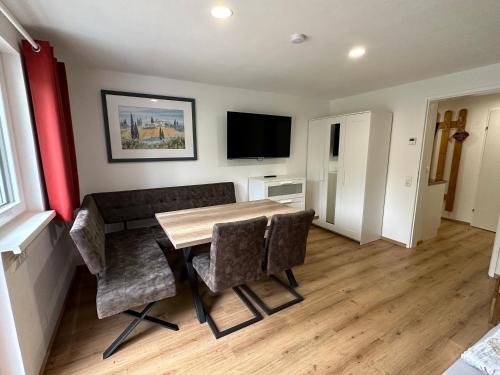 a dining room with a wooden table and chairs at Auszeit Salzkammergut Appartements in Bad Ischl