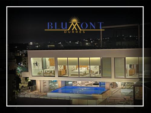 a building with a sign that reads bluemont dunlords at Luxury Rooftop Suites by Blumont in Durrës