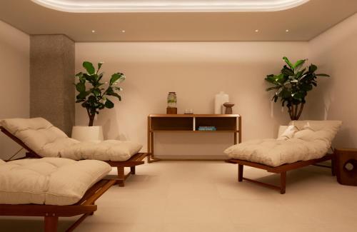 a room with two chairs and a table with plants at Bluesun Hotel Maestral in Brela