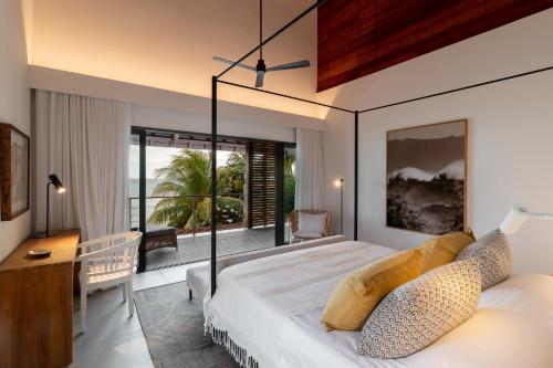 a bedroom with a large bed and a balcony at Villa Saphir by muse villas in Bambous