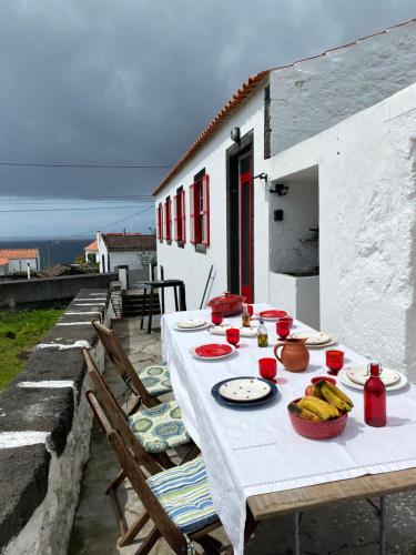 a white table with food on top of a house at PicoComigo in Lajes do Pico