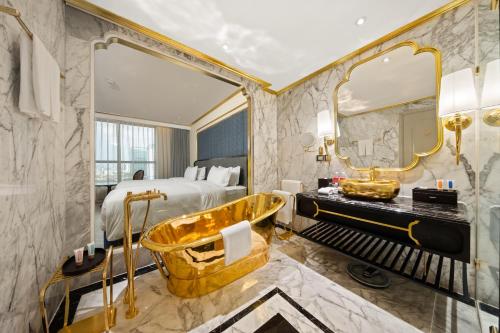 a hotel room with a tub and a bed at Dolce by Wyndham Hanoi Golden Lake in Hanoi