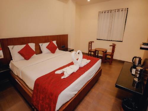 a hotel room with a bed with a towel on it at Aparupa Ambience in Port Blair