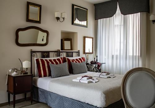 a bedroom with a bed with two towels on it at Albergo Merùo in Morano Calabro