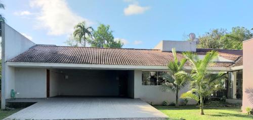 a house with a garage in front of it at Bèlla Chacara Morretes - Pr in Morretes