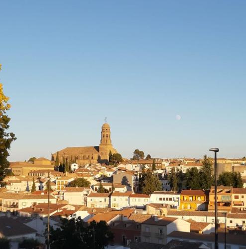 a city with a clock tower in the background at Vive el Renacimiento: Ochío in Baeza